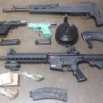 A man wanted by U.S. Marshals allegedly had these firearms and marijuana in his home when he was arrested.