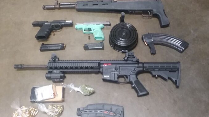 A man wanted by U.S. Marshals allegedly had these firearms and marijuana in his home when he was arrested.