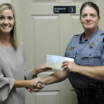 Amanda Formyduval presents Sgt. Pam Bryan with a check from the Good Shepherd Fund.