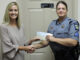 Amanda Formyduval presents Sgt. Pam Bryan with a check from the Good Shepherd Fund.