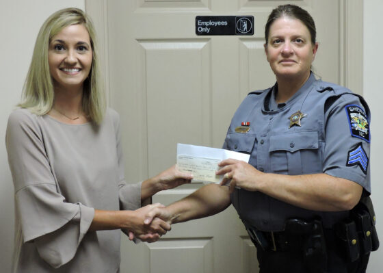 Amanda Formyduval presents Sgt. Pam Bryan with a check from the Good Shepherd Fund.