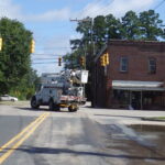 A Duke Power truck carefully makes its way through the Hallsboro intersection under the dark stoplights.