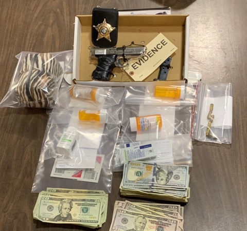 Drugs, cash and a .380 handgun were confiscated after an early morning raid near Chadbourn. (CCSO Photo)