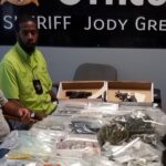 Sheriff Jody Greene, Chief of Detectives Jeremy Barber and Barrett Thompson of the Vice Narcotics unit with some of the drugs and other contraband seized during Friday's raids.