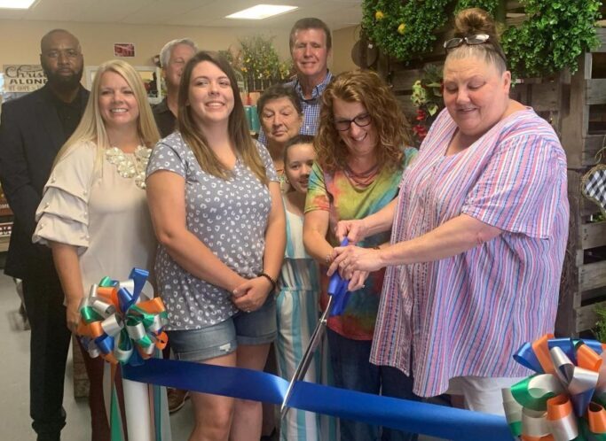 Angie Fowler cuts the ribbon officially opening Down South Home and Decor and Gifts last week. (Ben Proctor photo)