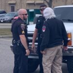 Whiteville Emergency Management Director Hal Lowder speaks with officers Wednesday after a potential suicide was stoped at Walmart. (Ben Proctor)