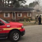 Smoke billows from under the eaves of the home. Firefighters were on the scene within a few minutes.