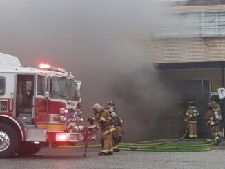 Firefightersprepare to enter the closed Radio Shack during Friday's fire.