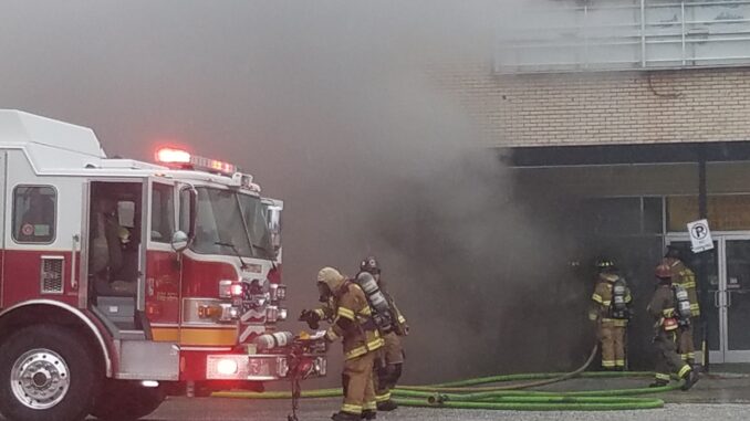 Firefightersprepare to enter the closed Radio Shack during Friday's fire.