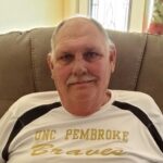 A man wearing a white and black T-shirt