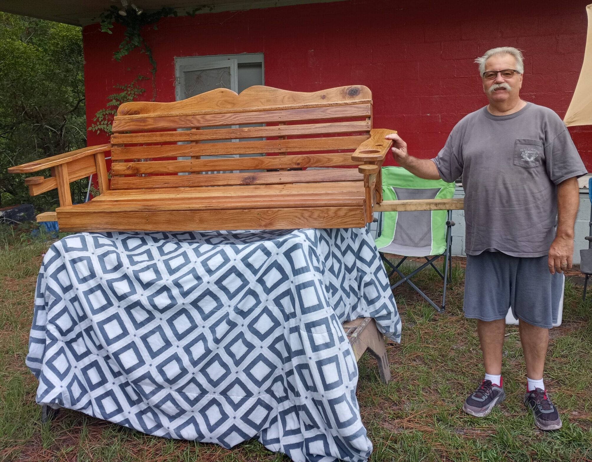 Delisle with one of his signature porch swings.