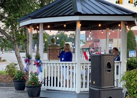 Lori Harper sings for the crowd at Monday's ceremony in Tabor City.