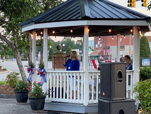 Lori Harper sings for the crowd at Monday's ceremony in Tabor City.