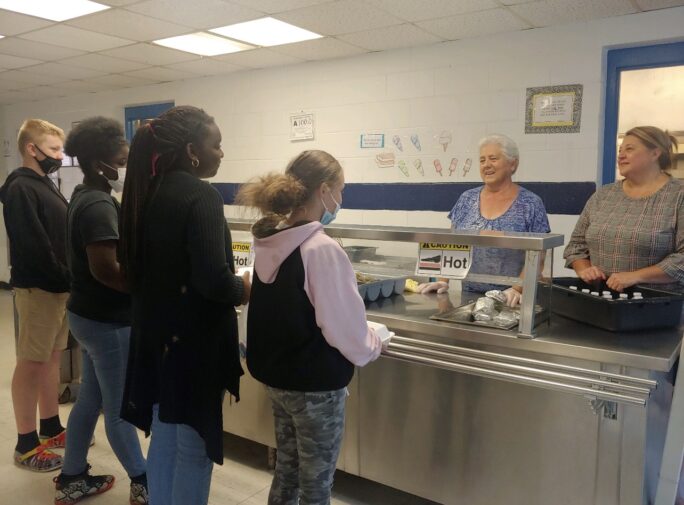 Clariece Hammonds and Selina Gore greet some of the summer lunch guests.