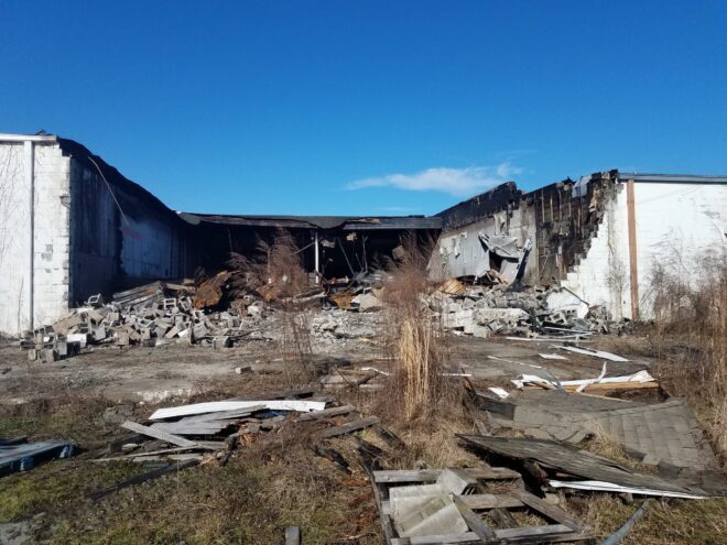 Little more than walls remain in some parts of the shopping center. Heavy equipment was used to knock down sections of the roof and walls after flames got inside the structure.