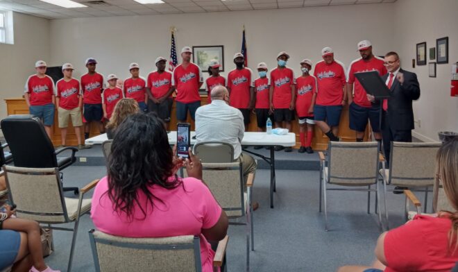 Mayor Daniel Hilburn reads the resolution honoring the DYB World Champion Riegelwood team Tuesday.