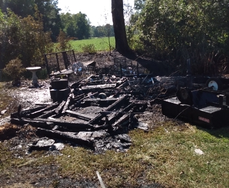 The blaze destroyed this outbuilding near a home in Wooded Acres Friday (today).