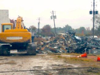 Piles of debris behind the old Lewis Smith Shopping Center were apparently set on fire Thursday evening.