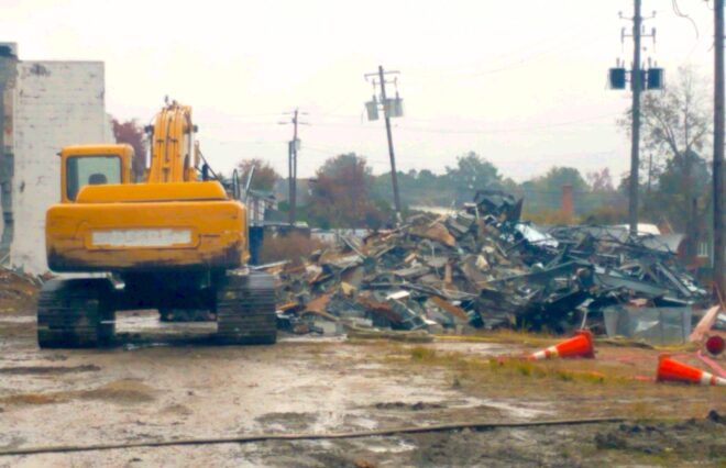 Piles of debris behind the old Lewis Smith Shopping Center were apparently set on fire Thursday evening.