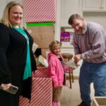 Dave Heller accepts Paisley Stevens' donation of $85 for the CBA Toy Store. Paisley's mother, Ash-Leigh Hewitt Stevens, thought Paisley was saving up for an iPhone.