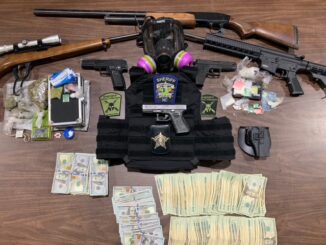 Firearms, drugs, cash and body armor were confiscated in the raid. (CCSO photo)