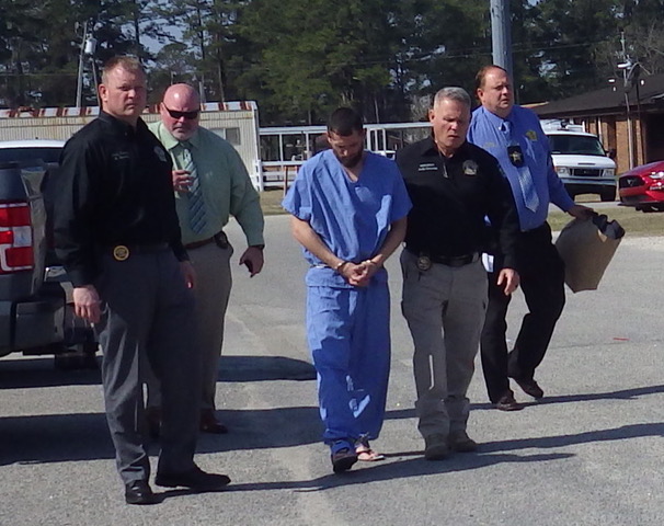 Spivey is flanked by Chief Deputy Aaron Herring, Sheriff Jody Greene and other CCSO personnel.