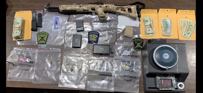 Drugs, cash and a firearm were seized after a raid in bolton. (CCSO photo)