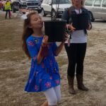 A happy recipient picks up her tree at a recent giveaway event. (Contributed)