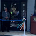 Rep. Brenden Jones, flanked by Sheriff Jody Green and county officials, speaks to the crowd Wednesday.