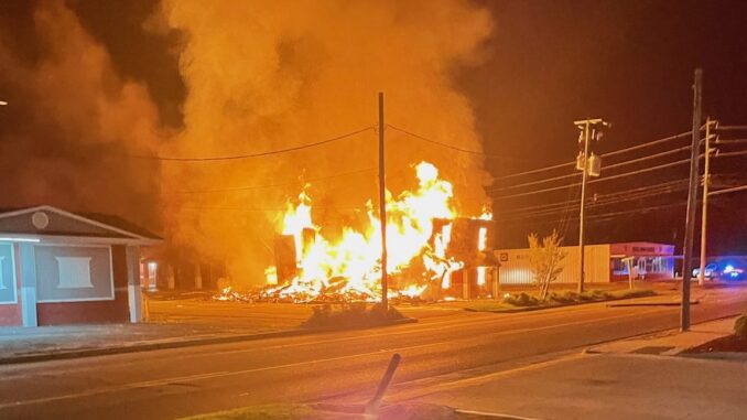 Flames shoot through the remains of one of the buildings at the Budget Inn early Wednesday. (Fire Marshal photo)