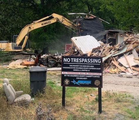 Sheriff Jody Greene wasted no time after announcing the nuisance abatement order against this property on Dessie Road. The sheriff manned the excavator used to demolish the home right after Friday's press conference. (submitted).