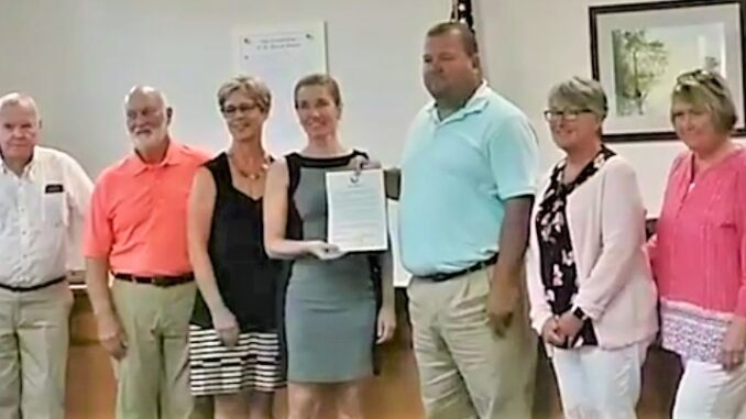 Megan Kopek received a copy of a declaration recognizing International Widows Day at Tuesday's Lake Waccamaw Town Commissioners meeting. Mayor Matt Wilson presented the proclamation, which was read by Commissioner Rosemary Dorsey.