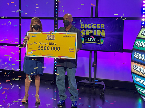 DarrellRiely with a ceremonial check at state lottery headquarters. (Submittedphoto)