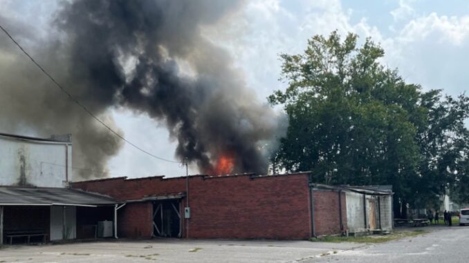Firefighters from multiple departments are in Fair Bluff, trying to stop a structure fire from spreading to more buildings downtown.