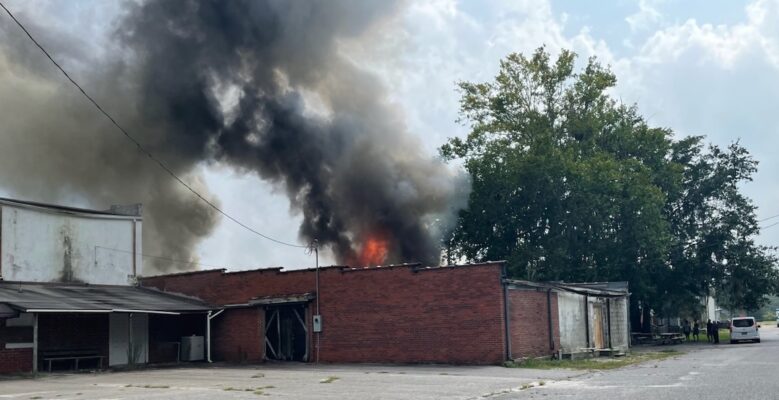 Firefighters from multiple departments are in Fair Bluff, trying to stop a structure fire from spreading to more buildings downtown.