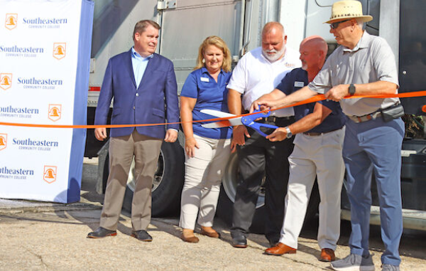 Rep. Brenden Jones, Angie Ransom, Scott Hartley, Dr. Chris English, and Fair Bluff town board member Randy Britt cut the ribbon for the new truck driving training school. (SCC Photo)