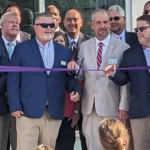 Members of the county school board, commissioners, Tabor School staff and Rep. Brenden Jones at Thursday's ribbon cutting. (Robert Nealy photo)