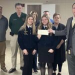 Jess Hill of the county fair board presents a check to members of the ECHS FFA. (submitted)
