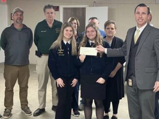 Jess Hill of the county fair board presents a check to members of the ECHS FFA. (submitted)