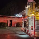 Firefighters make entry through the roof during Saturday’s fire at the WTXY transmitter building.