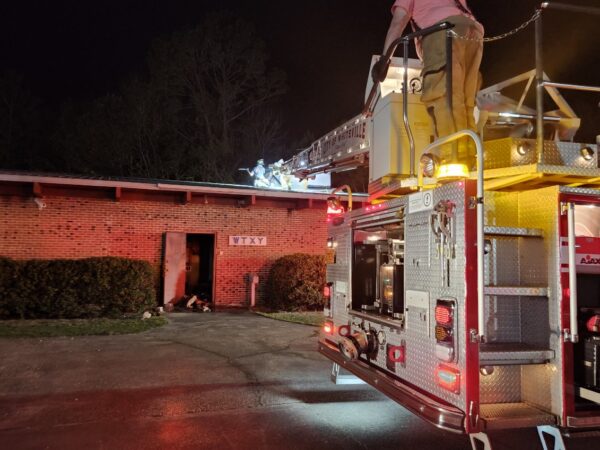 Firefighters make entry through the roof during Saturday’s fire at the WTXY transmitter building.