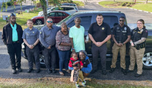 The search team with Joe Baldwin and his family. (CCSO Photo)