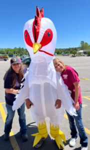 Santana Miller, Sue Miller and the Farm Store's mascot chicken.