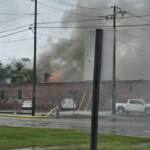 Flames break through the roof of a storage building behind the old ice house in Whiteville (Photos and video courtesy Glasgow Hicks)
