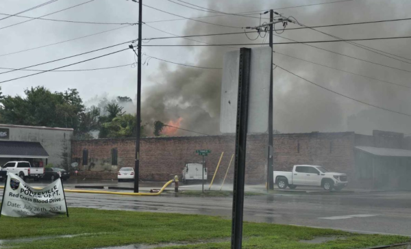 Flames break through the roof of a storage building behind the old ice house in Whiteville (Photos and video courtesy Glasgow Hicks)