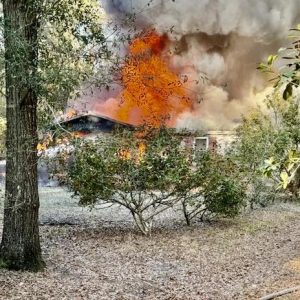 Smoke from the burning home was visible across the Cape Fear River in Riegelwood. (ADR photo)