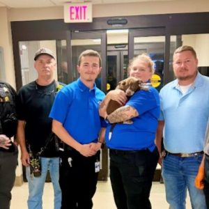CCSO Deputies and APS staff with Whiteville Rescue personnel and the puppy who was administered Narcan. (CCSO Photo/Facebook)