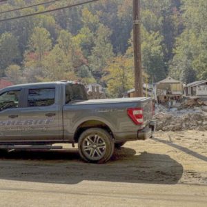 A CCSO patrol vehicle near the remains of homes in western North Carolina. (CCSO photo)