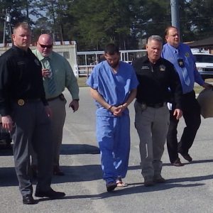 Spivey is flanked by Chief Deputy Aaron Herring, Sheriff Jody Greene and other CCSO personnel.