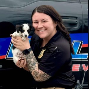 Sgt. Brianna Blanks and the puppy that was thrown out of a vehicle window Saturday.